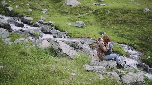 一位年轻的女性徒步旅行者带着照相机爬山。罗马尼亚喀尔巴阡山脉的transagarasan视频素材