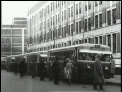 1932年蒙太奇人群和旅游巴士在汽车工厂大楼外/密歇根，美国视频素材