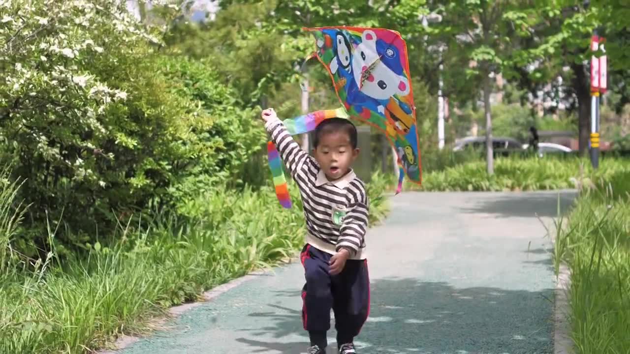 Hd高清升格视频中国小朋友在公园树林中放风筝视频素材画面1