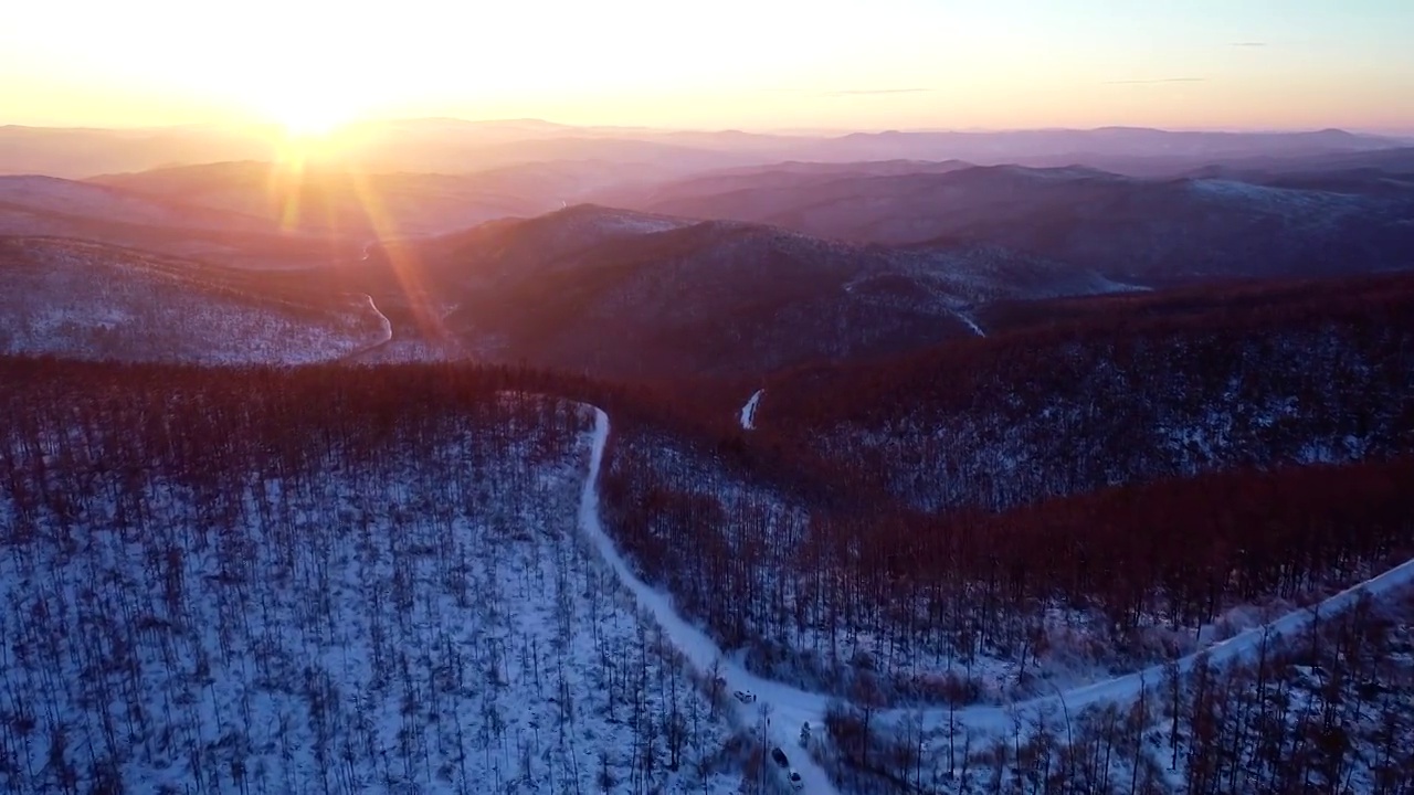 航拍大兴安岭冬季雪域山林雪路暮色视频素材