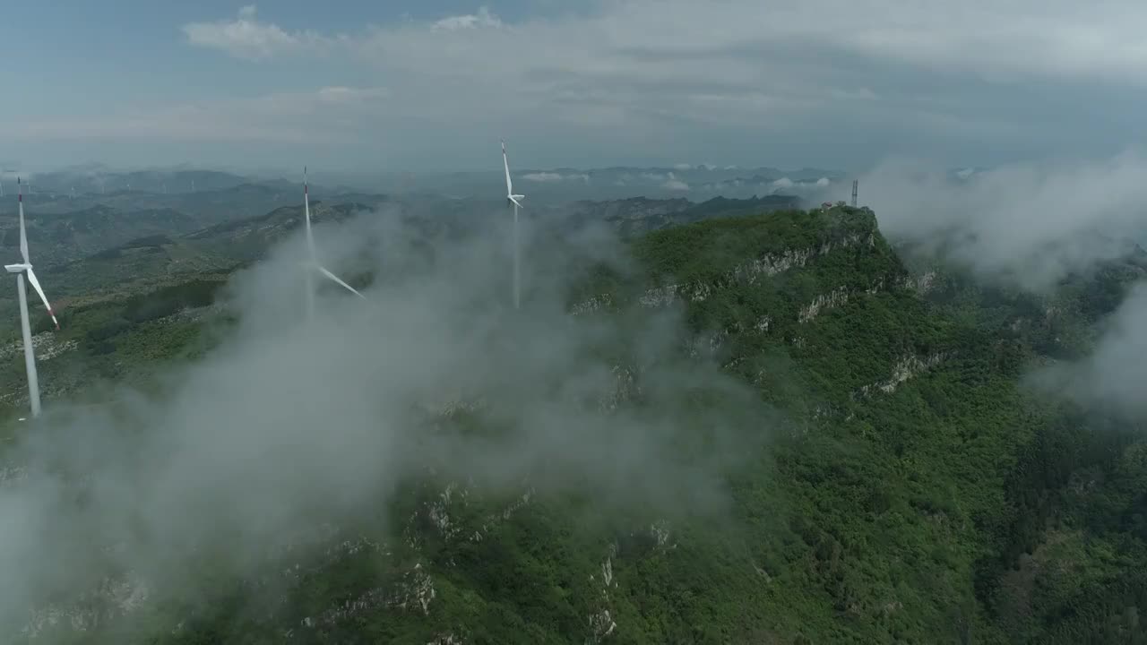 航拍山脉森林穿越云雾风力发电视频素材