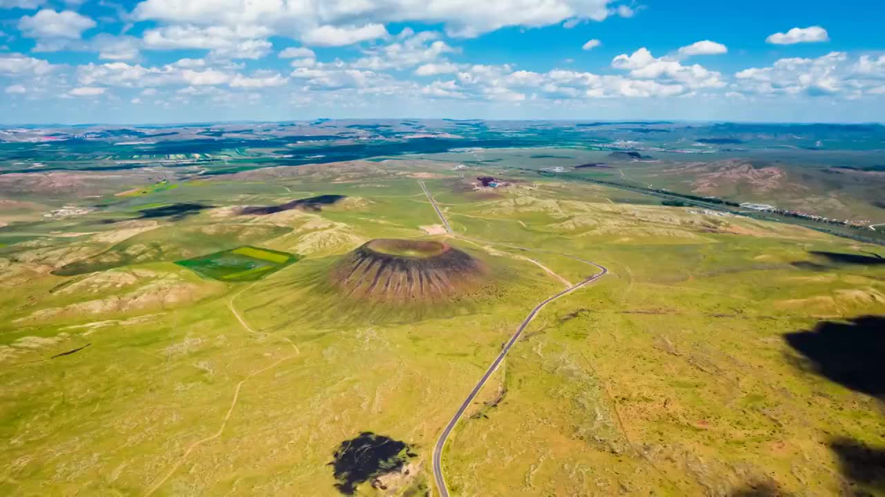 中国内蒙古乌兰察布乌兰哈达火山三号火山航拍和公路延时摄影视频素材