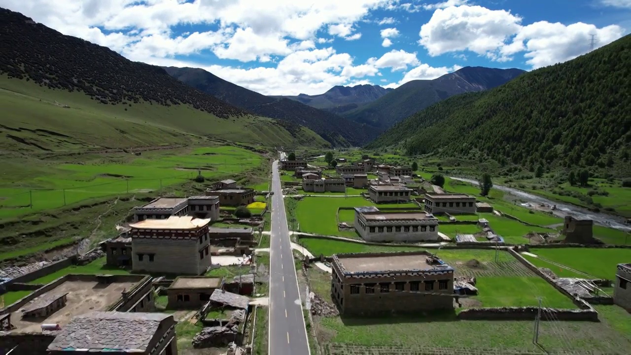 航拍四川川西甘孜州乡城县田园风光，初夏的青稞田白藏房和山谷自然风光。视频素材