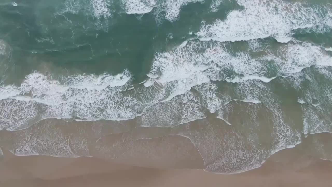 航拍海南省文昌市月亮湾沙滩的海浪视频素材