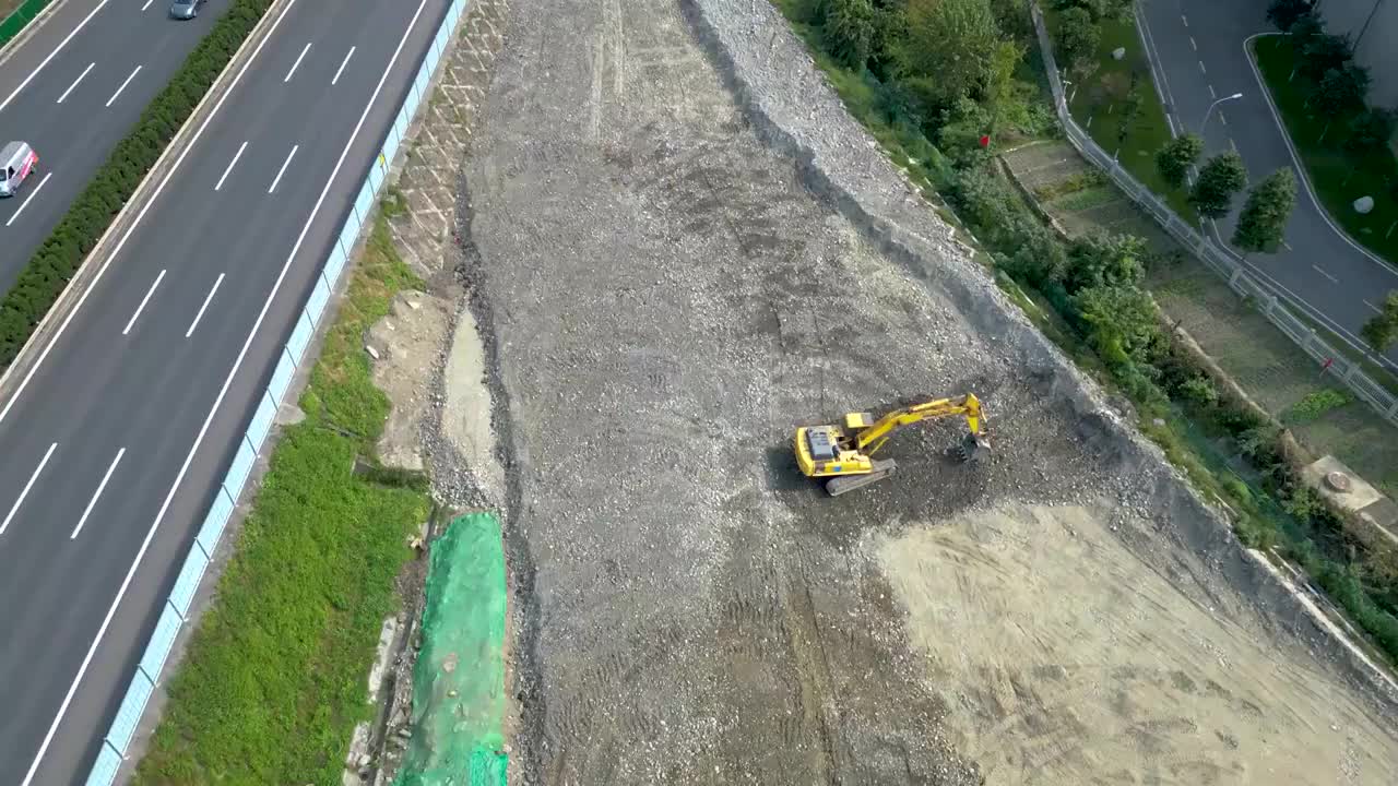 航拍成都五环路改造工程：正在成灌高速公路施工的挖掘机视频素材