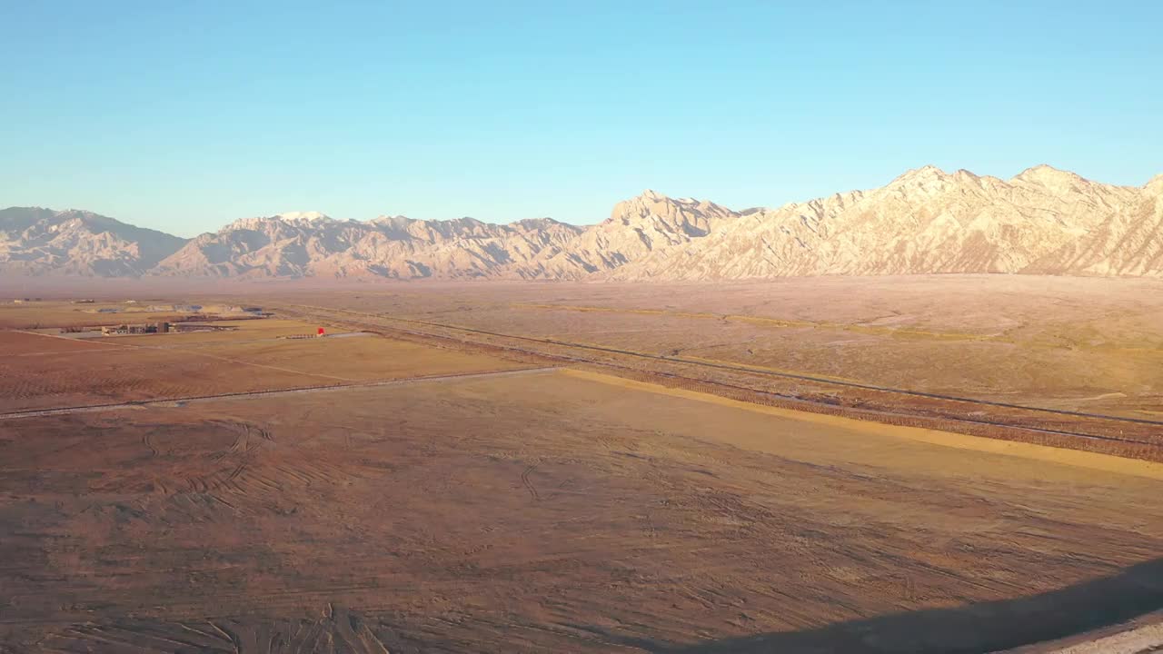 航拍空中鸟瞰雪后贺兰山睡佛日出视频素材