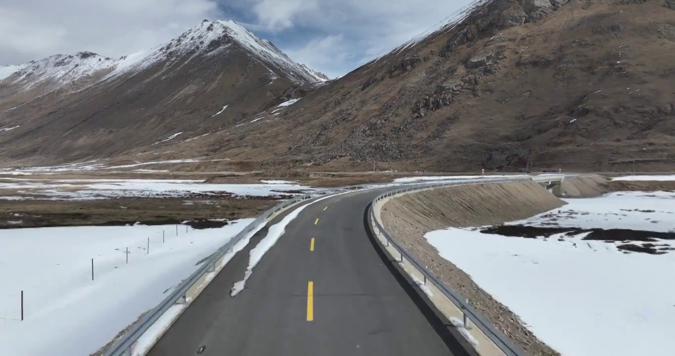 航拍青藏高原高海拔雪原中积雪的道路视频素材