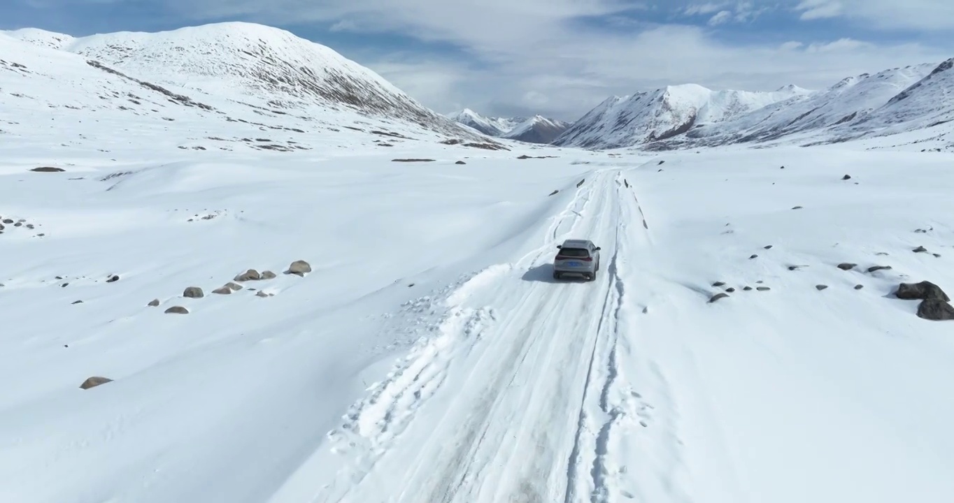 越野车SUV行驶在青藏高原高海拔雪原中积雪的道路上视频素材