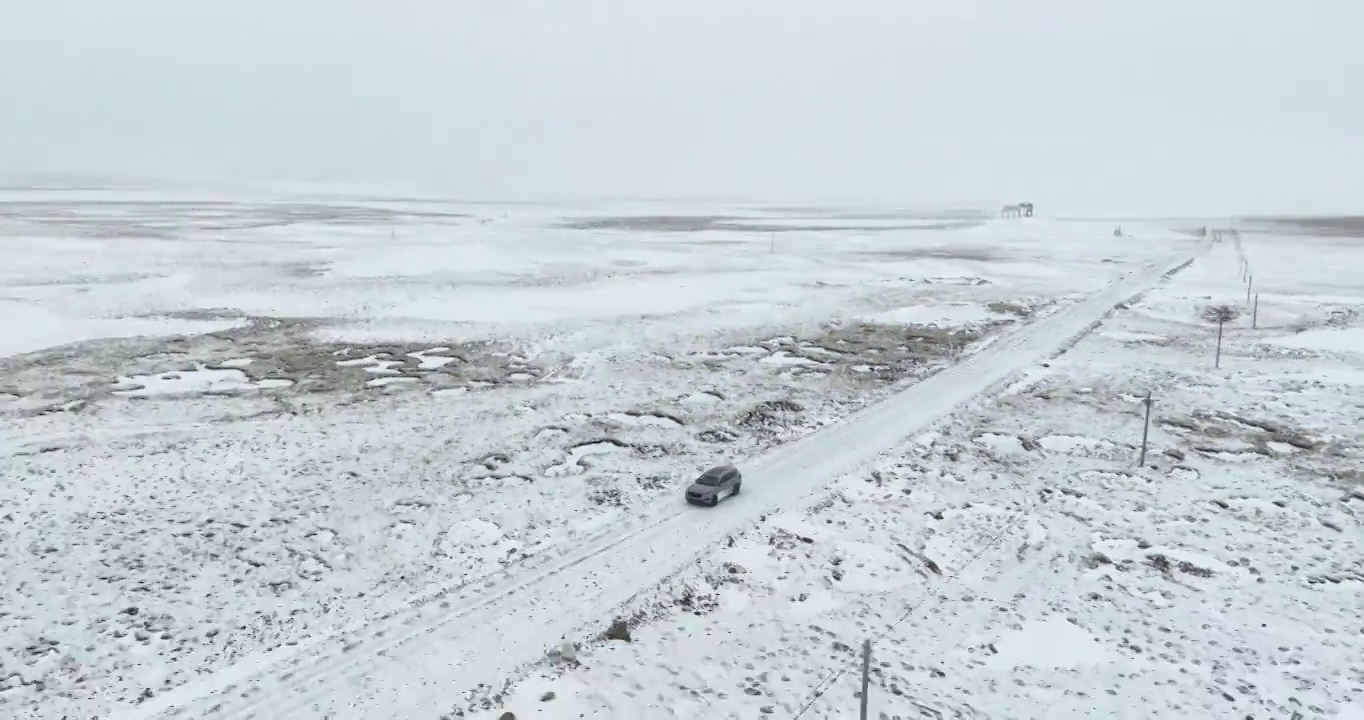 越野车SUV行驶在青藏高原高海拔雪原中积雪的道路上视频素材