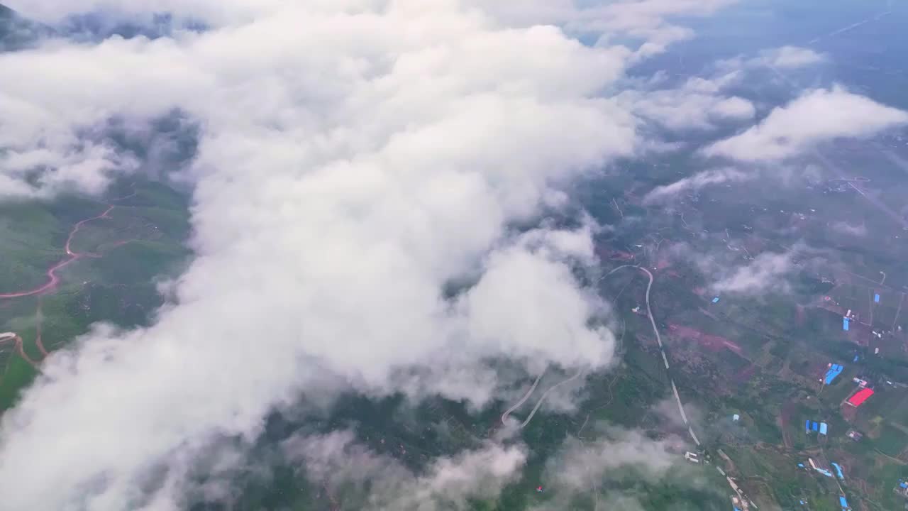 从云层上航拍太行山以及山脚下的高速路和南水北调中线渠视频素材