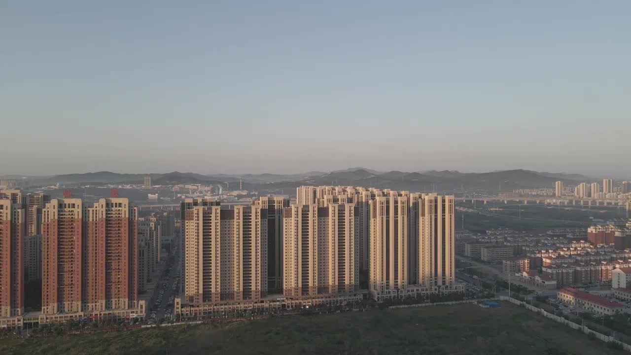 山东省烟台市莱山区高新区城市建筑群日出航拍视频素材