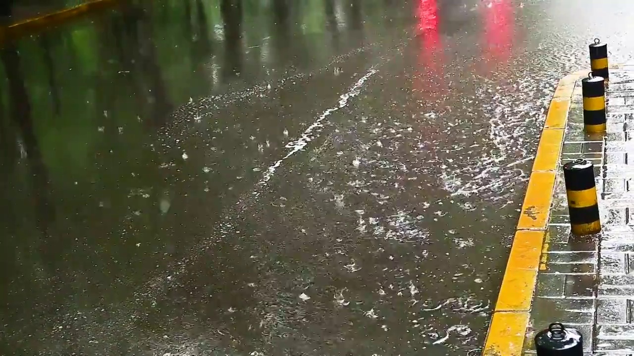 城市里汽车驶过雨水的马路积水路面视频素材