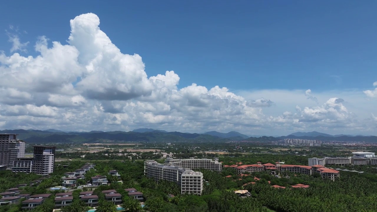 航拍蓝天白云下三亚海棠湾及海岸线五星级酒店群视频素材