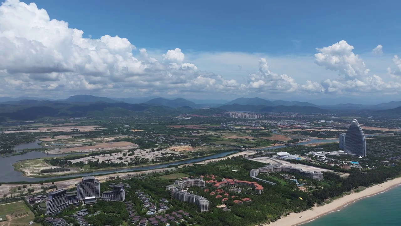 航拍蓝天白云下三亚海棠湾及海岸线五星级酒店群视频素材