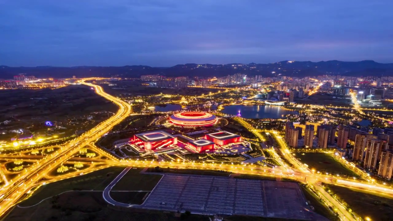 成都龙泉驿大运会主场馆和东安湖体育公园夜景航拍环绕移动延时摄影视频素材