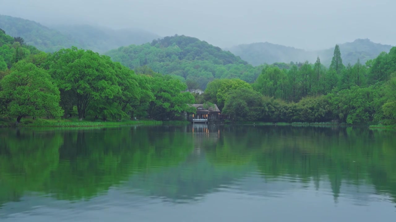 江南杭州西湖浴鹄湾春天阴雨天春雨中的山与茅草屋自然治愈风景视频素材