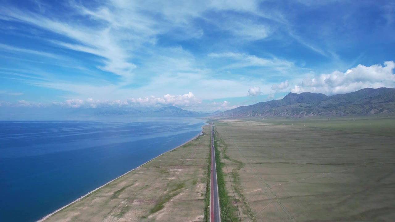 航拍新疆旅游赛里木湖环湖道路蓝色湖景视频素材