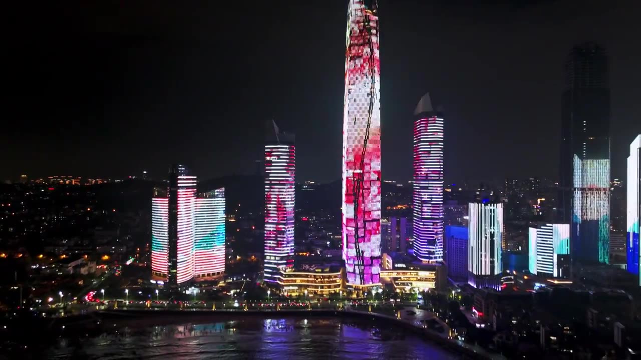 中国山东青岛城市夜景灯光秀航拍海边繁华城市高楼鸟瞰视频素材