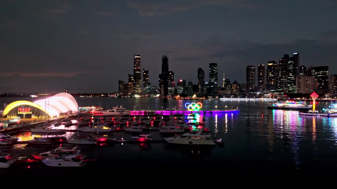 中国山东青岛城市夜景灯光秀航拍繁华城市高楼鸟瞰视频素材