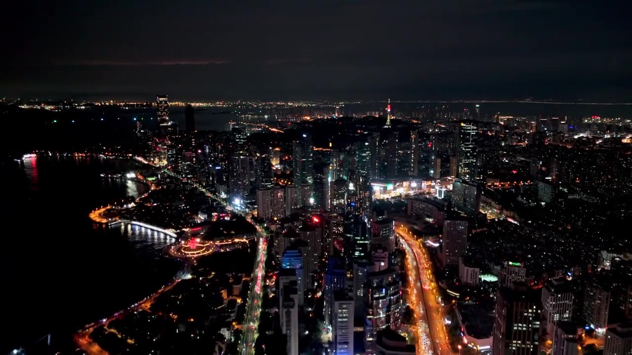 中国山东青岛城市夜景灯光秀航拍繁华城市高楼鸟瞰视频素材