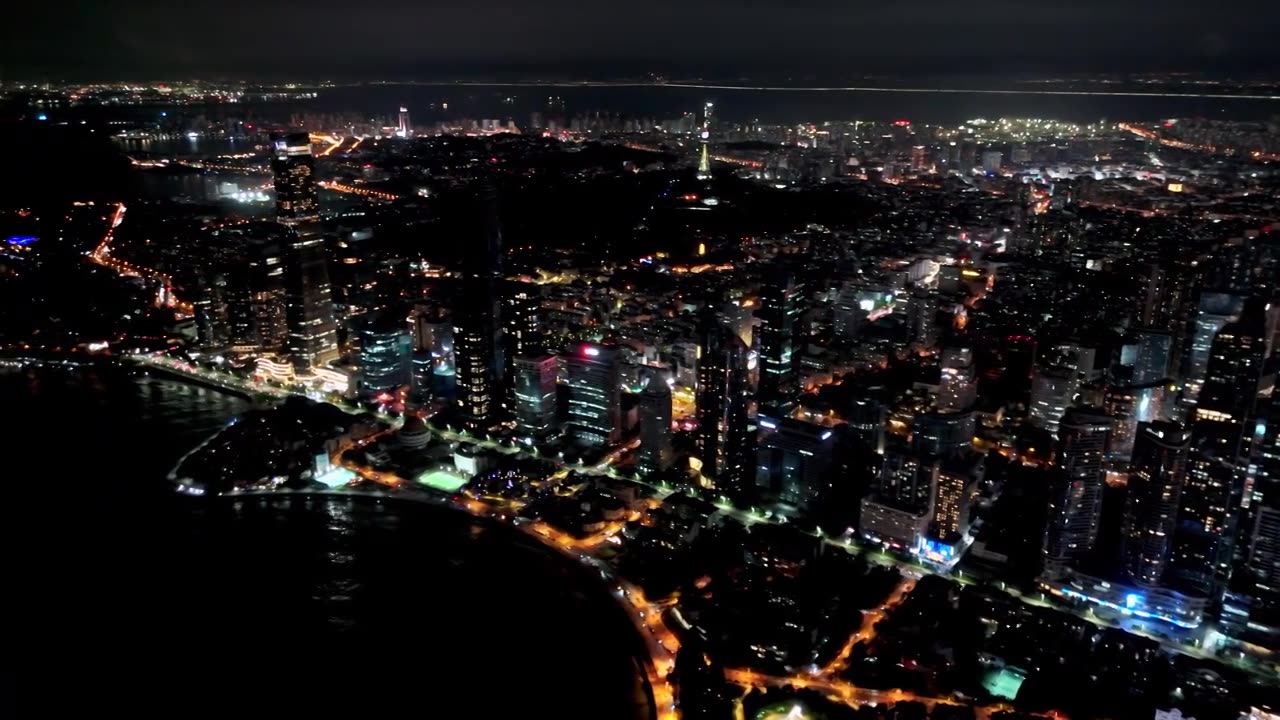 中国山东青岛城市夜景灯光秀航拍繁华城市高楼鸟瞰视频素材