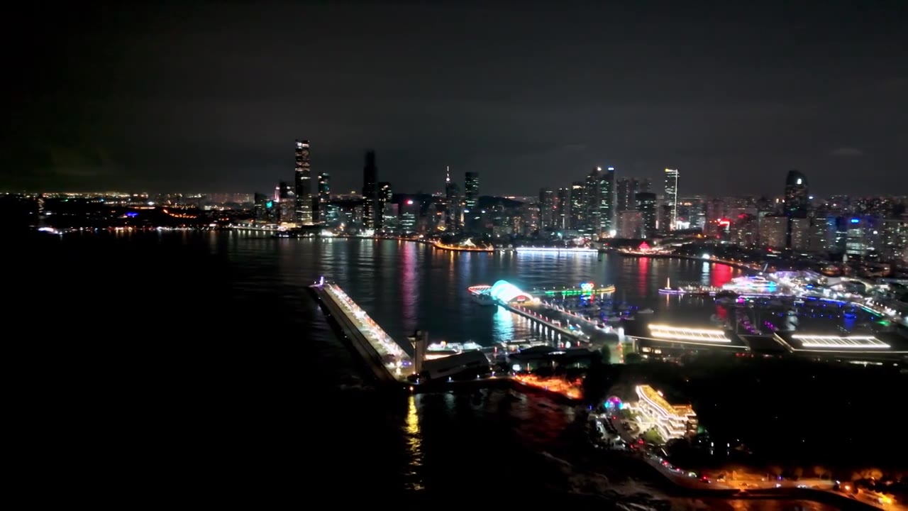 中国山东青岛城市夜景灯光秀航拍繁华城市高楼鸟瞰视频素材