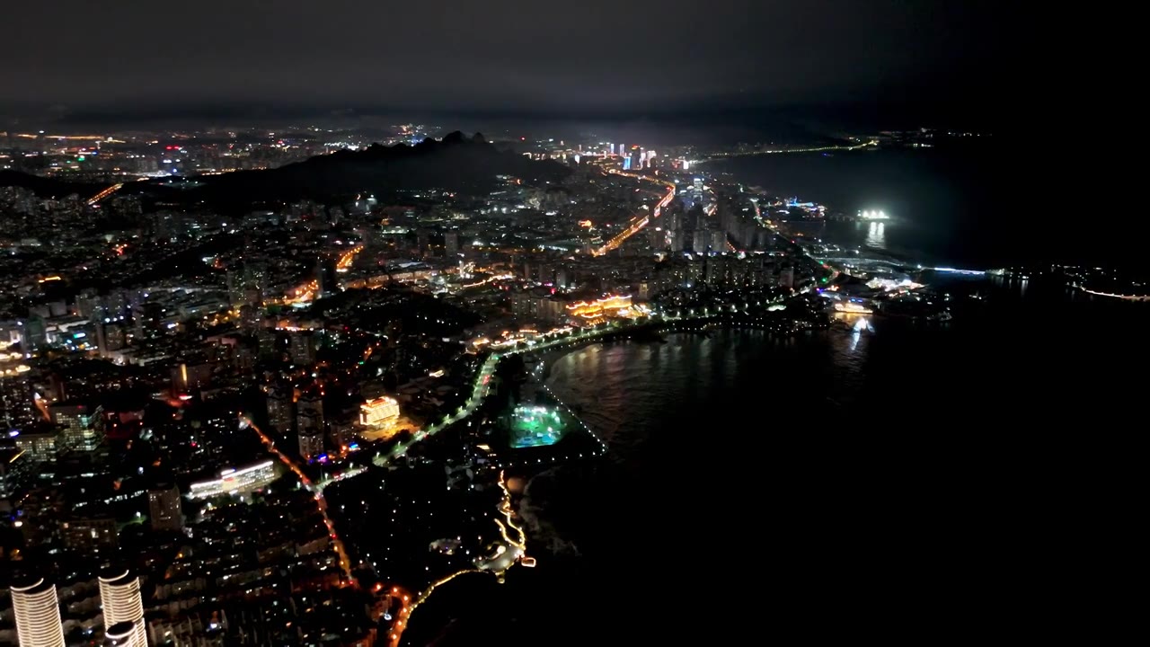 中国山东青岛城市夜景灯光秀航拍繁华城市高楼鸟瞰视频素材