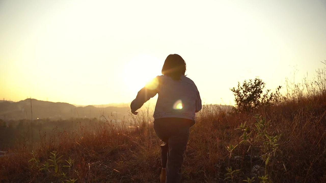 登山漫步看日出看日落的女孩，唯美黄昏视频素材画面2