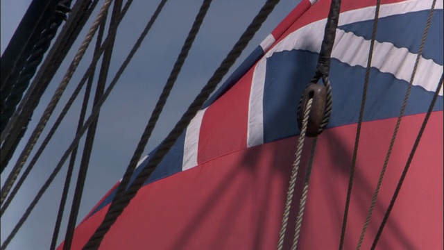英国皇家海军“奋进号”(HMS Endeavour)的复制品上飘扬的红色红旗(1707-1801)。视频素材画面2