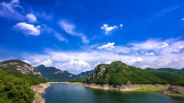 在Oksunbong山脉之间的中柱湖(由河流大坝形成的多用途湖)摆渡的延时拍摄视频素材