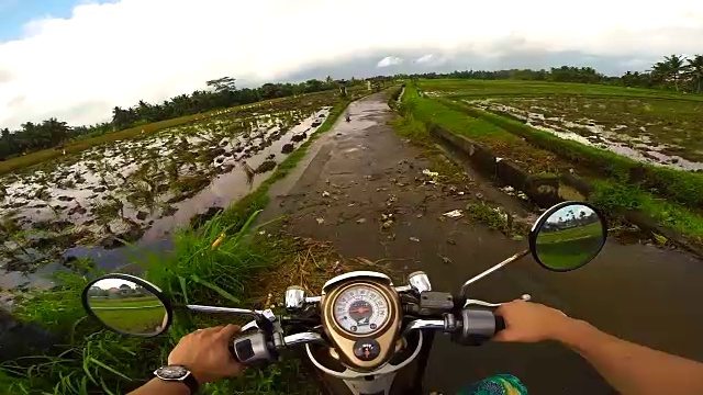 在巴厘岛旅行度假期间，夫妇从个人的角度记录道路使用行动摄像头，而骑摩托车在巴厘岛的道路。视频素材