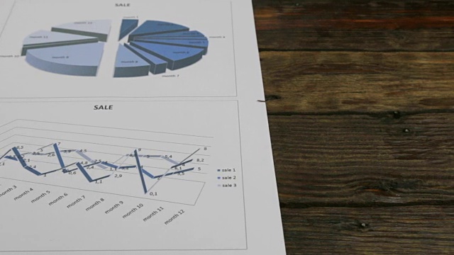滑动相机的运动。木桌上放着一张纸和图表视频素材