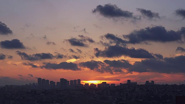 时光流逝，城市上空多云的天空上的日落视频素材