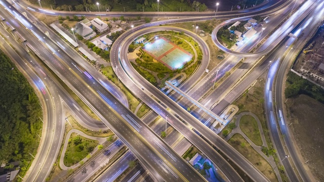 4K时间推移:鸟瞰图高速公路公路环岛或十字路口，圆在晚上的运输，分配或未来的背景。视频素材