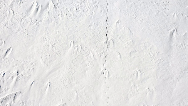 一个男人正走在雪地上。孤独。从以上观点。视频素材画面2