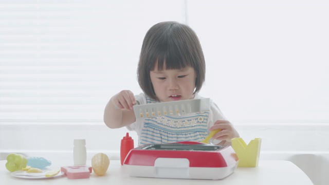 小女孩在家玩食物玩具视频素材