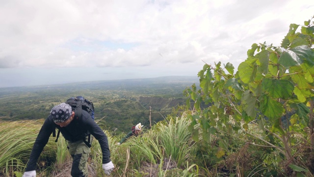 两个疲惫的徒步旅行者到达了山顶视频素材