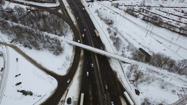 Car moving on freeway overpass at winter. 无人机查看路口公路视频素材