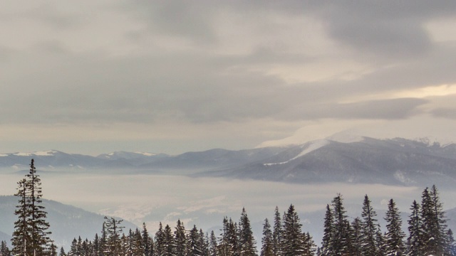 山峰上的雪被风吹走了。冬天的风景。天很冷，下着雪。视频素材