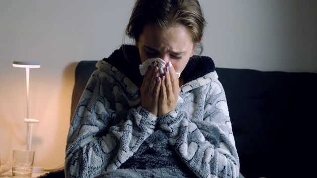 年轻妇女发烧，打喷嚏视频素材