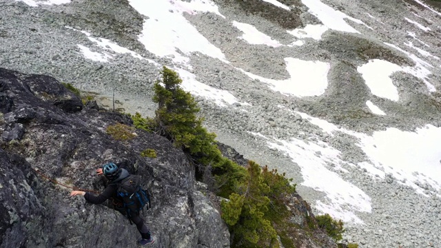 从空中俯瞰女性登山者攀登岩石峭壁视频下载