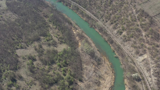 在乡村河边跟随火车拍摄4K无人机视频视频素材