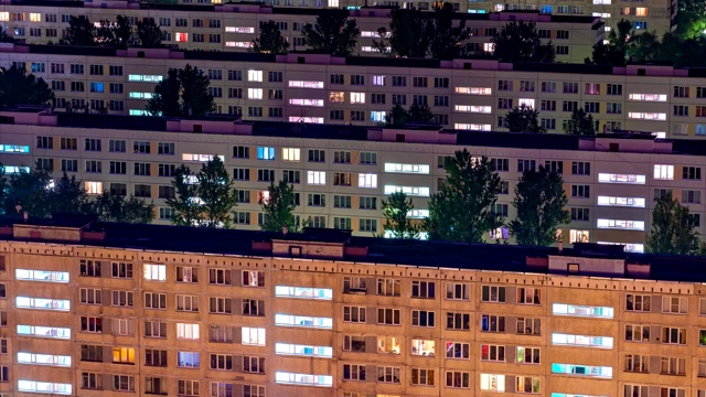 夜晚城市中住宅区的时间流逝，公寓的窗户里亮着灯光视频素材