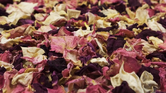 旋转一堆干玫瑰花瓣。花的背景。视频素材画面2