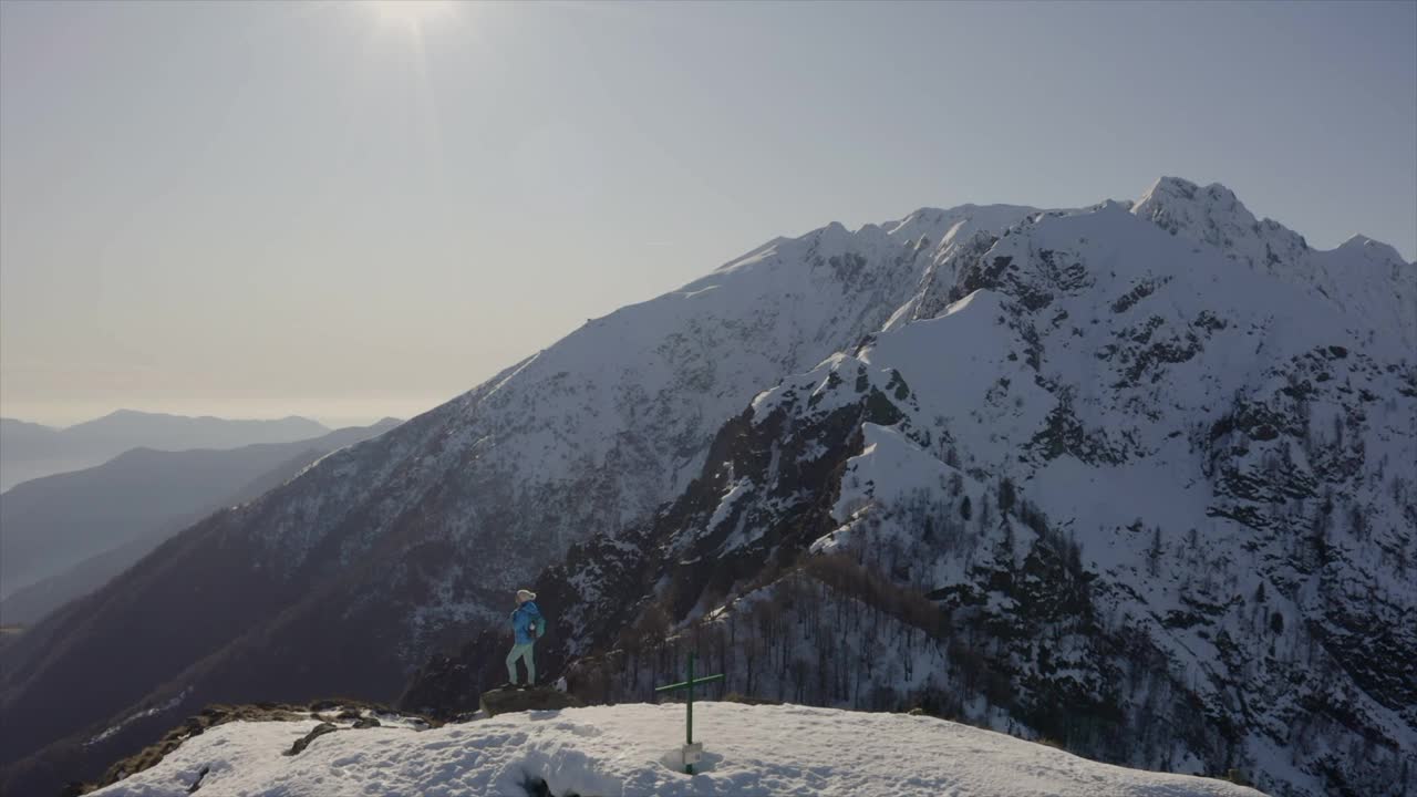 独自的女性旅行者庆祝从山顶攀登成就。无人机视频素材