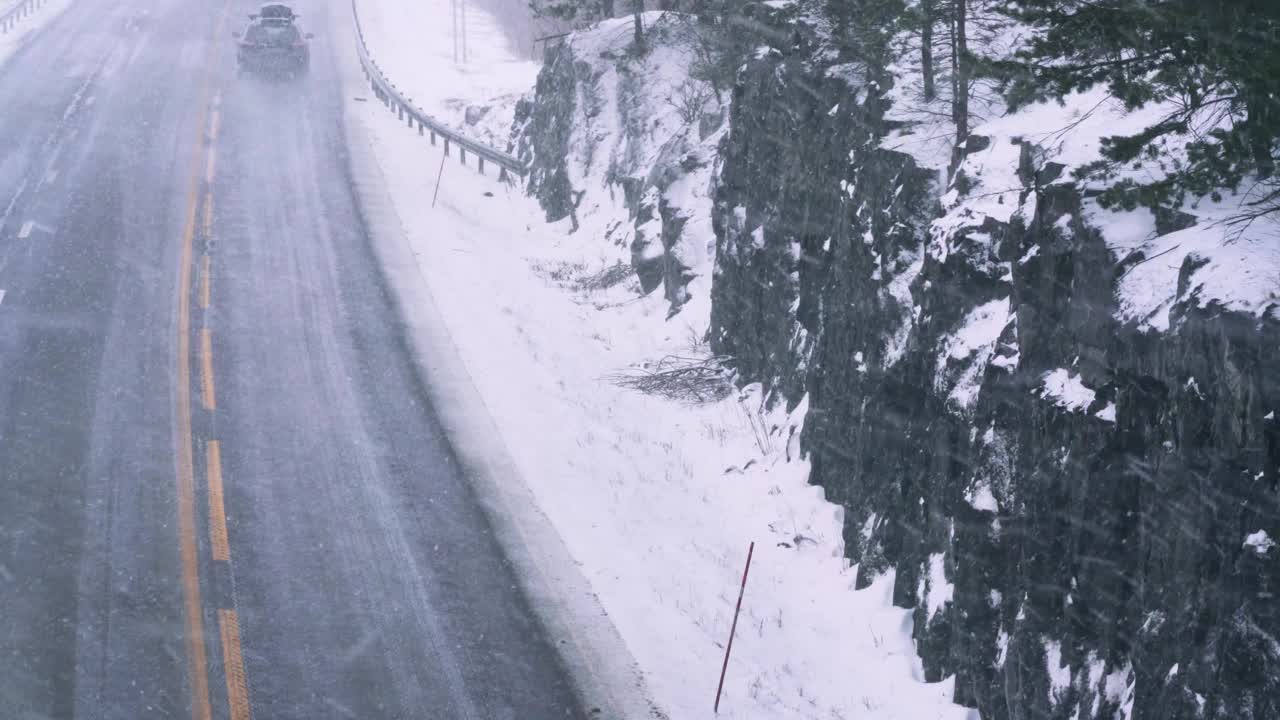 在冬季的一天，在暴风雪中高速公路上的交通使驾驶变得危险。视频素材