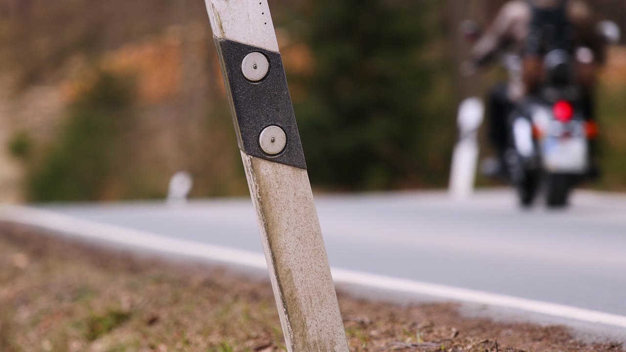 一辆摩托车在乡村公路上飞驰而过，塔架模糊不清视频素材画面1