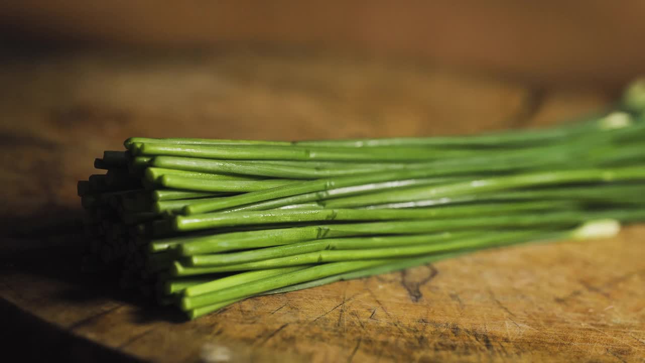 用刀切韭菜的亚洲老太太。准备烹饪菜单。亚洲食品。泰国菜。素食。视频素材