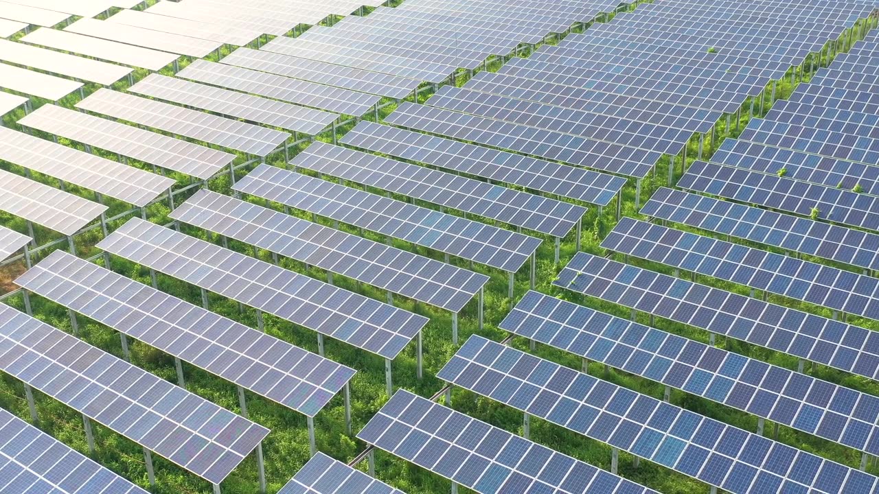太阳能农场太阳能板反射阳光工业工厂的4K鸟瞰图。视频素材画面2