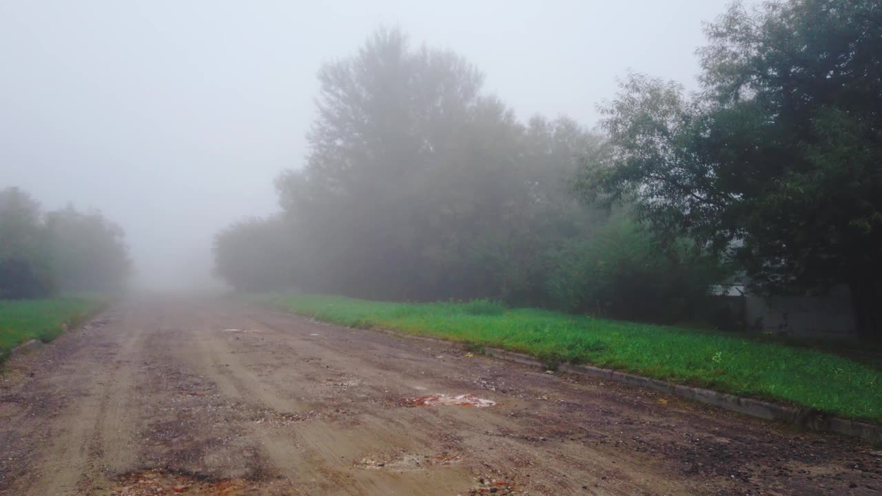 在雾中走在崎岖的路上。大雾街道上的动态视频素材